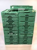 A quantity of green plastic folding trays, length 60 cm.
