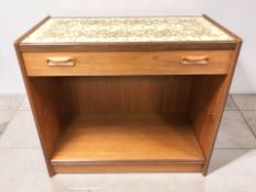 A 20th century G-Plan teak single drawer side table with tile inset top and shelves beneath,