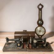 Two antique Singer hand sewing machines and an oak banjo barometer.