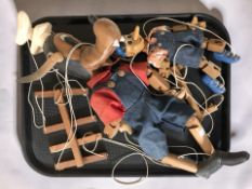 A jointed wooden Pinocchio puppet and a further Pluto the Dog puppet.