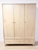 A contemporary oak veneered triple door wardrobe,