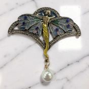 An Art Nouveau-style enamel and gilded metal brooch.