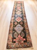 A Heriz runner, North West Iran, 430 cm x 87 cm.