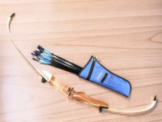 A Longshot TD-01 Trainer archery bow and a quiver of arrows.