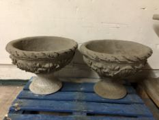 A pair of concrete garden planters on plinth bases,