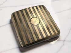 A George V two-tone silver cigarette case, Abrahams Brothers, Birmingham 1923, length 9cm.