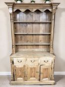 A Victorian style pine dresser fitted cupboards and drawers beneath,