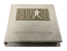 An Elvis Presley EP collection folder containing records.