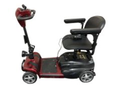 A mobility scooter with two keys and charger.