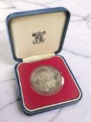 An 1883 USA Silver Dollar, boxed.