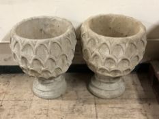 A pair of concrete pineapple planters,