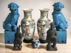 A group of oriental wares including a pair of porcelain baluster vases on wooden stands,