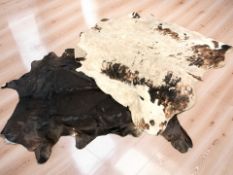 Two cow skin rugs, approximately 205 cm x 200 cm.