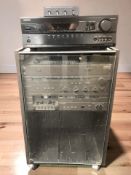 An Onkyo receiver TX-SR507 and a record cabinet containing a Team 31 De Luxe hi/fi system