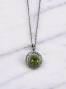 A silver pendant on chain set with natural 3ct peridot.
