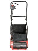 An Einhell electric lawnmower.