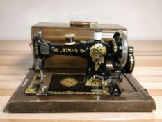 A Jones antique hand sewing machine in walnut box.