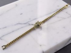 A gilded metal Cartier-style panther head bracelet set with cubic zirconia.