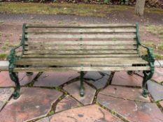 A painted cast iron and and teak garden bench, with lion's head terminal arm rests, length 163 cm.