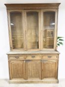 A Victorian glazed oak bookcase, fitted cupboards and drawers beneath,