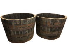 A pair of coopered oak half barrel planters, diameter 66 cm.