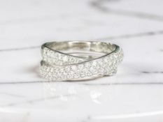An 18ct white gold diamond cross-over ring set with forty two diamonds,