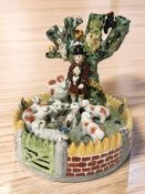 A Staffordshire style spill vase surmounted by a shepherd and flock, height 20 cm.