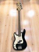 A Rockburn left handed electric bass guitar.