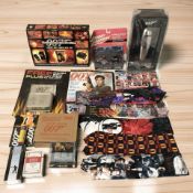 James Bond collectibles including die cast cars, cocktail shaker, cologne, playing cards, ties,