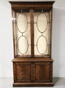 A reproduction mahogany double door display cabinet,