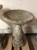 A concrete garden bird bath,