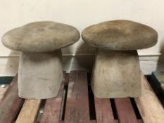 A pair of concrete staddle stones,