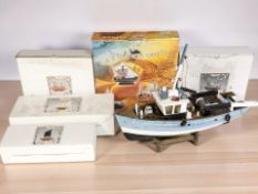 A wooden scale model of a fishing trawler and several further boat models including Leonardo.