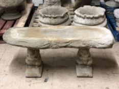 A log effect concrete garden bench on squirrel supports,