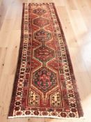 A Heriz runner, 330 cm x 95 cm.
