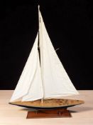 A large model of a yacht on wooden stand,