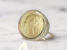 A 9ct gold ring set with a Victorian shield back full sovereign 1866,