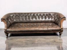 A late Victorian carved walnut Chesterfield three seater settee,
