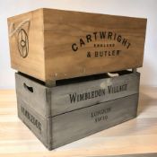 A pine crate with rope handles stenciled 