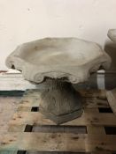 A concrete garden bird bath,