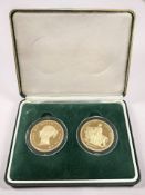 A pair of silver gilt £5 coins, copies replicating the original 