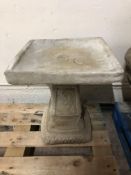 A concrete square garden bird bath,