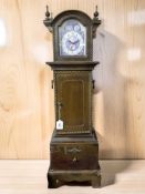 A miniature longcase clock with battery movement, height 85 cm.