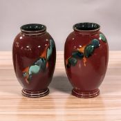 A pair of Poole lava pottery vases, height 20 cm.