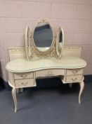 A five piece cream and gilt bedroom suite comprising of five drawer chest,