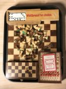 A chess set and board, a wooden travelling chess set, a magnetic set and a set of dominoes in box.