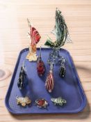 A group of studio glass fish ornaments.