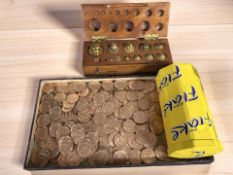 A graduated part-set of brass weights in wooden case and a tray of assorted Elizabeth II pennies.
