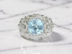 A cocktail style dress ring set with 4ct natural blue topaz and cubic zirconia.