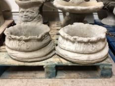 A pair of concrete large garden sack planters,